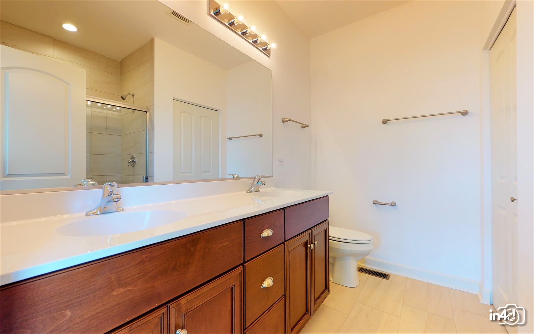 16436 Harmon Lane Plainfield, IL 60586 - Photo 23 of 30 a bathroom with a sink a toilet and shower