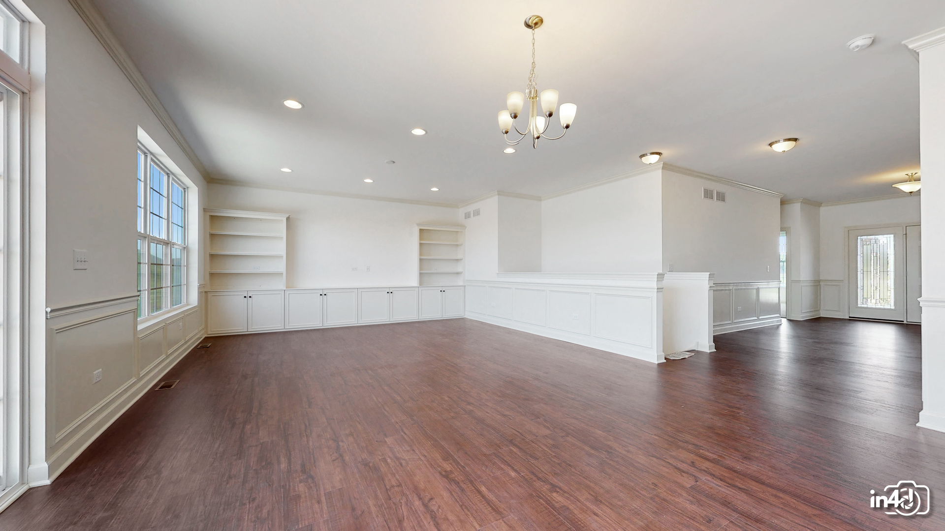 16436 Harmon Lane Plainfield, IL 60586 - Photo 5 of 30 an empty room with wooden floor and windows