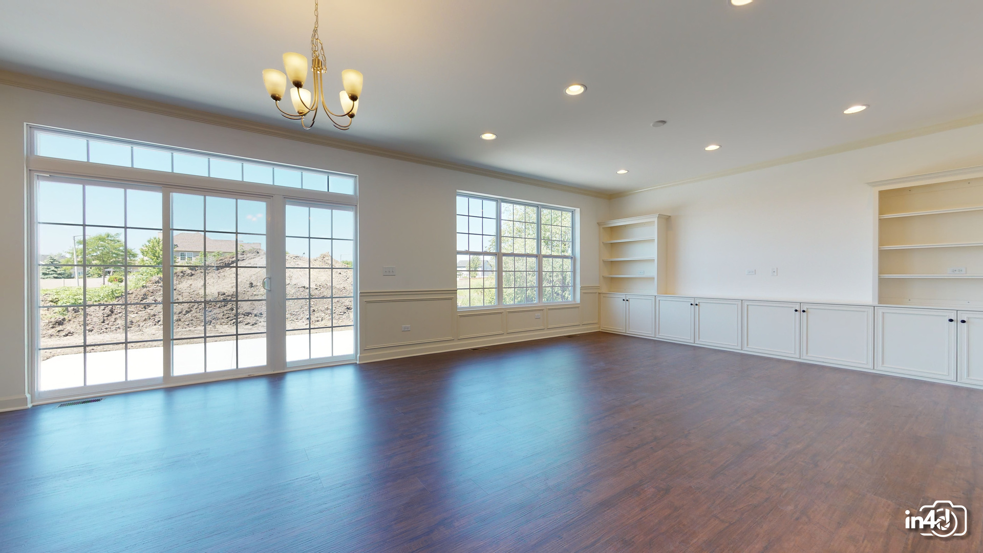 16436 Harmon Lane Plainfield, IL 60586 - Photo 6 of 30 a view of an empty room with wooden floor and a window