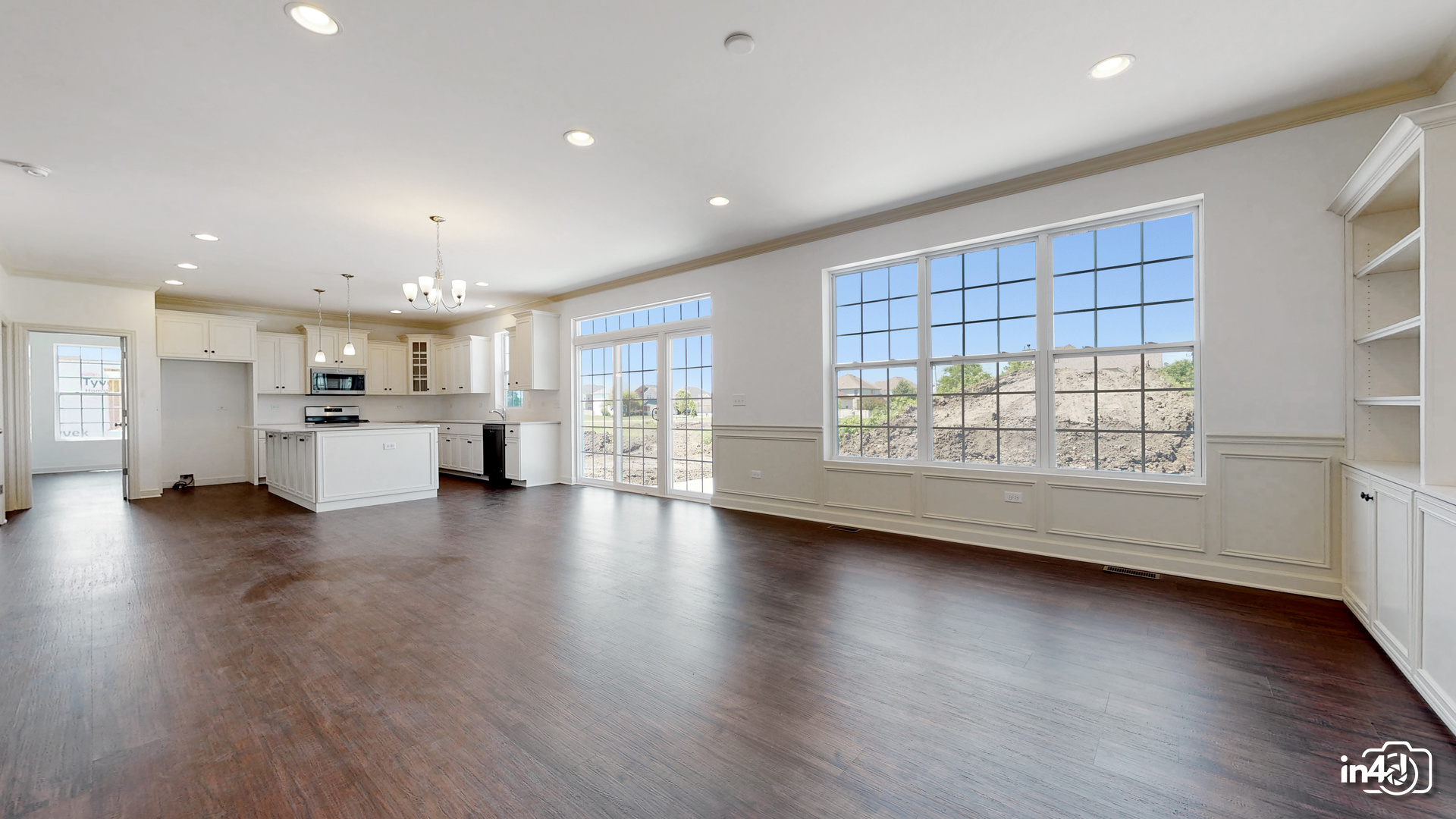 16436 Harmon Lane Plainfield, IL 60586 - Photo 10 of 30 a view of an empty room with a window and wooden floor