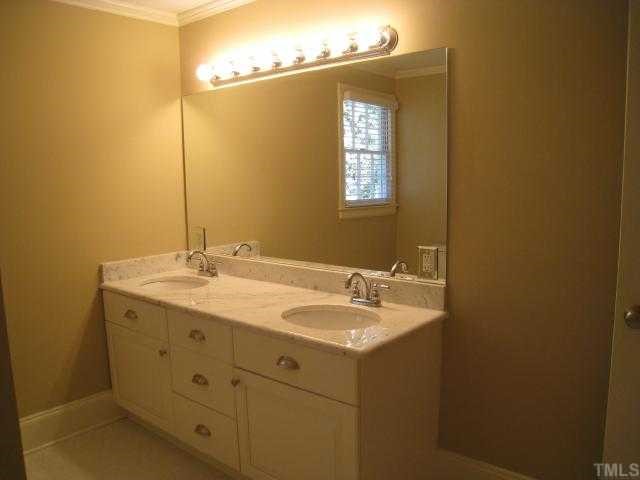 704 Davidson Street Raleigh, NC 27609 - Photo 11 of 12 a bathroom with a sink and a mirror