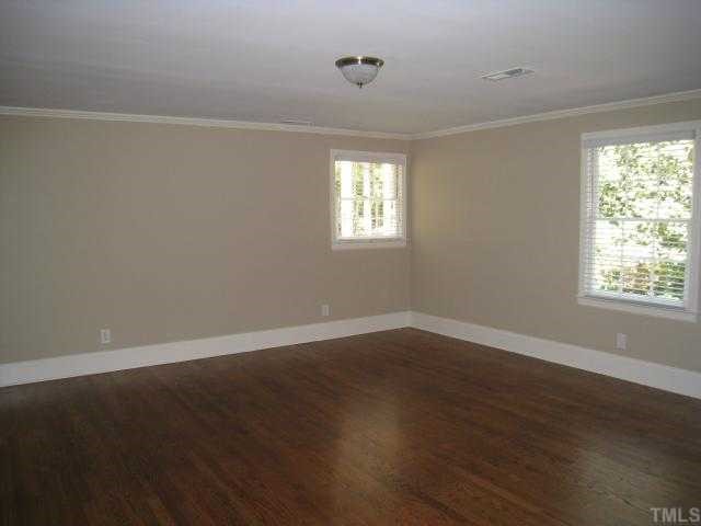 704 Davidson Street Raleigh, NC 27609 - Photo 12 of 12 a view of an empty room with wooden floor and a window