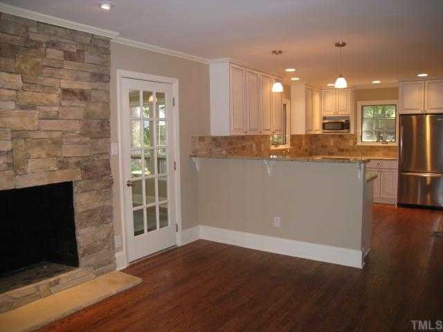 704 Davidson Street Raleigh, NC 27609 - Photo 2 of 12 a view of a kitchen with a sink and a fireplace