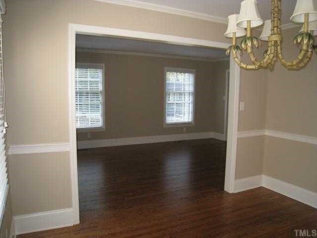 704 Davidson Street Raleigh, NC 27609 - Photo 8 of 12 a view of an empty room with wooden floor and a window