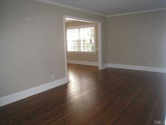 704 Davidson Street Raleigh, NC 27609 - Photo 9 of 12 an empty room with wooden floor and windows