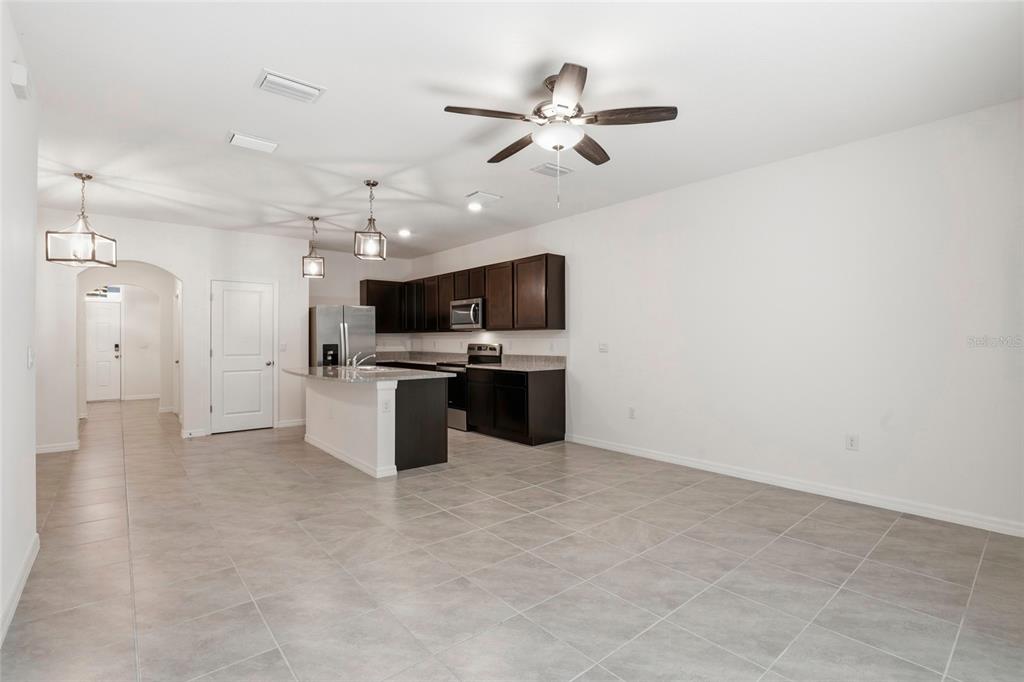 13775 Northwest 9th Road Newberry, FL 32669 - Photo 12 of 33 a large kitchen with cabinets and stainless steel appliances