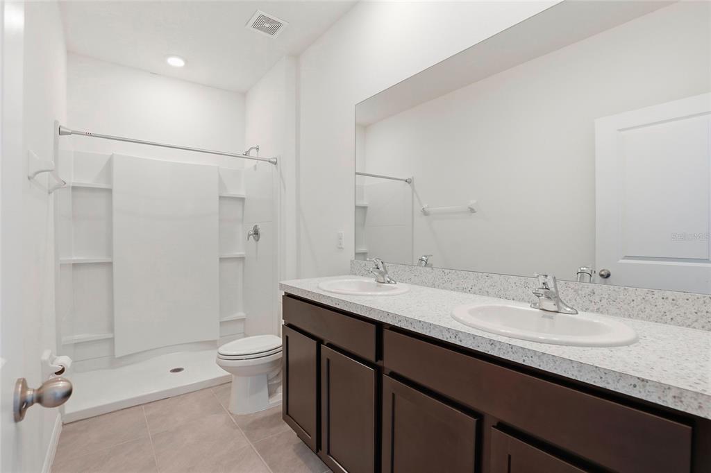 13775 Northwest 9th Road Newberry, FL 32669 - Photo 23 of 33 a bathroom with a granite countertop sink toilet and shower