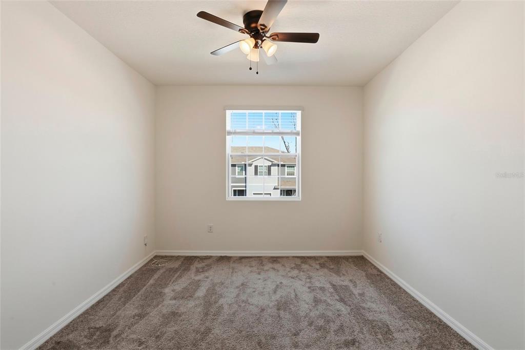 13775 Northwest 9th Road Newberry, FL 32669 - Photo 25 of 33 an empty room with a window and a ceiling fan