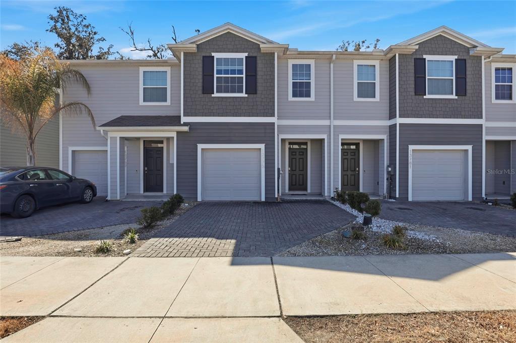 13775 Northwest 9th Road Newberry, FL 32669 - Photo 3 of 33 a front view of a house with a yard and garage