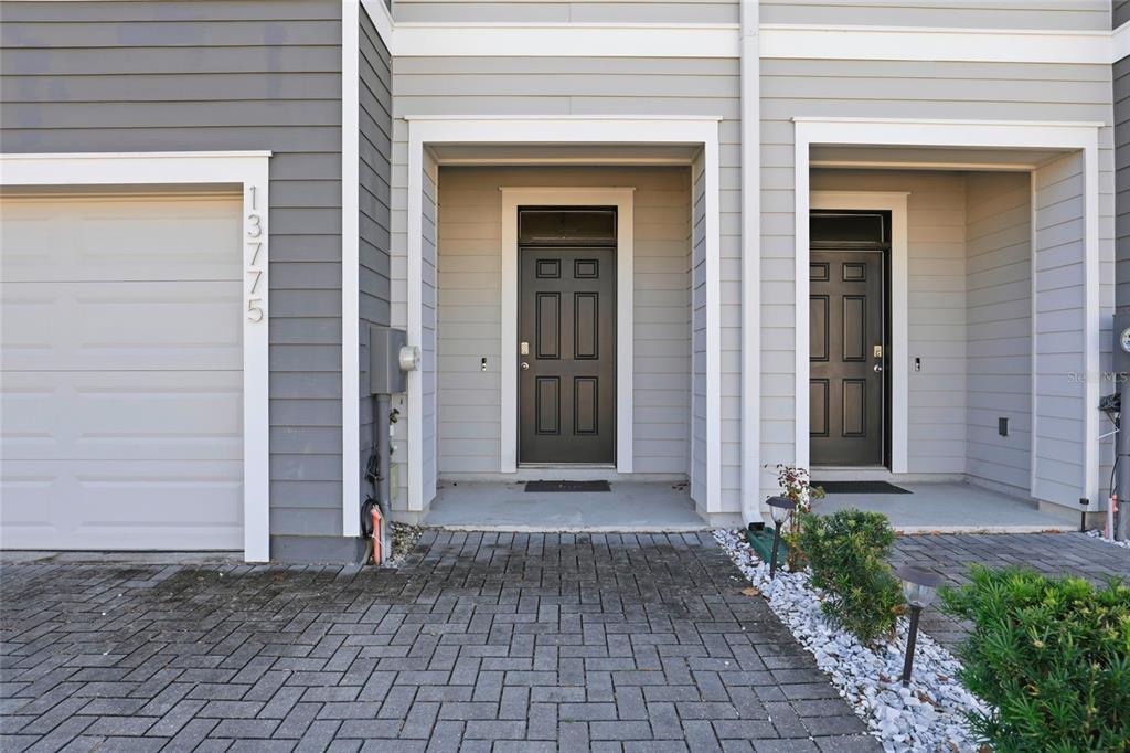 13775 Northwest 9th Road Newberry, FL 32669 - Photo 4 of 33 a front view of a house with a brick walls and a window