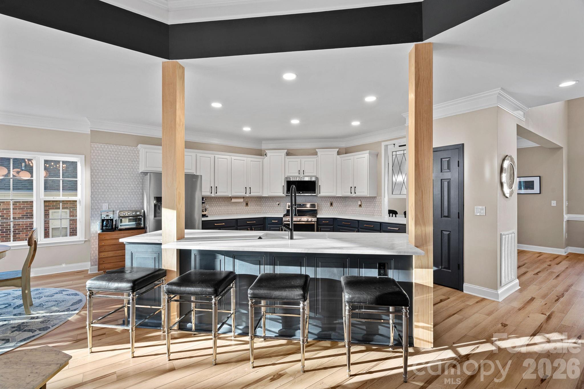 1470 Valhalla Drive Denver, NC 28037 - Photo 13 of 41 a kitchen with stainless steel appliances kitchen island granite countertop a dining table chairs and white cabinets