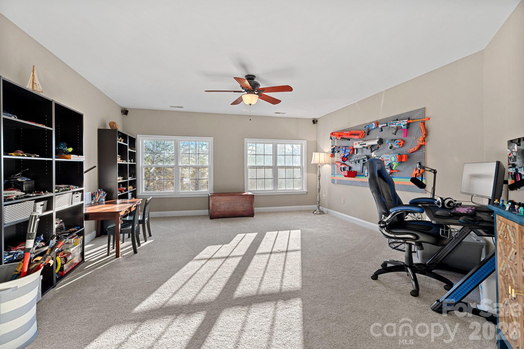 1470 Valhalla Drive Denver, NC 28037 - Photo 20 of 41 a living room with furniture a dining table and a fireplace