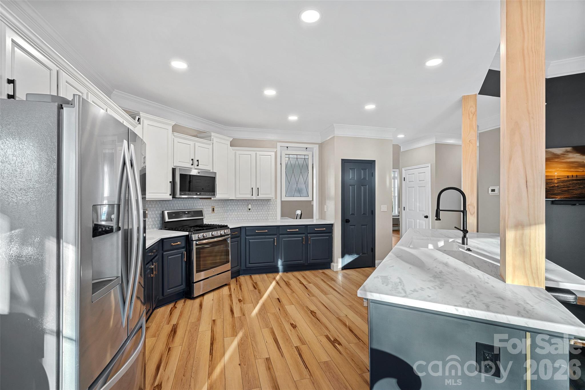 1470 Valhalla Drive Denver, NC 28037 - Photo 5 of 41 a large kitchen with stainless steel appliances a refrigerator a stove a sink dishwasher a oven with white cabinets and wooden floor