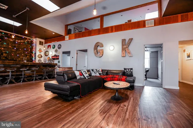 a view of a dining room with furniture and a chandelier