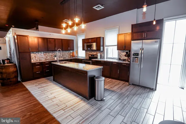 a living room with furniture gym equipment and a flat screen tv