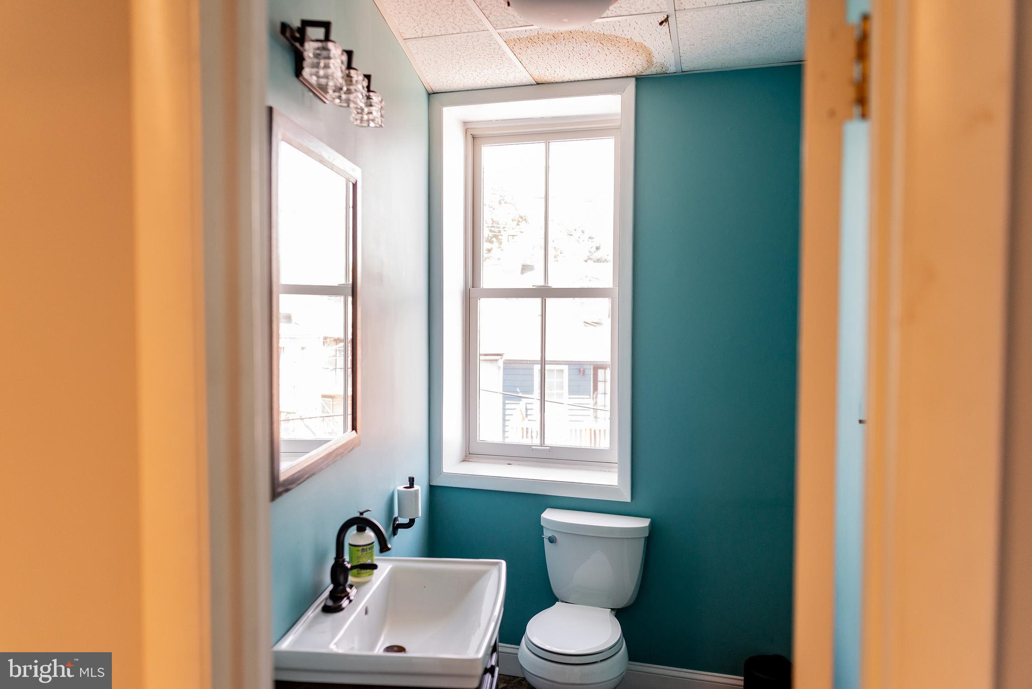 933 Rose Street Harrisburg, PA 17102 - Photo 47 of 98 a bathroom with a toilet a sink and a window