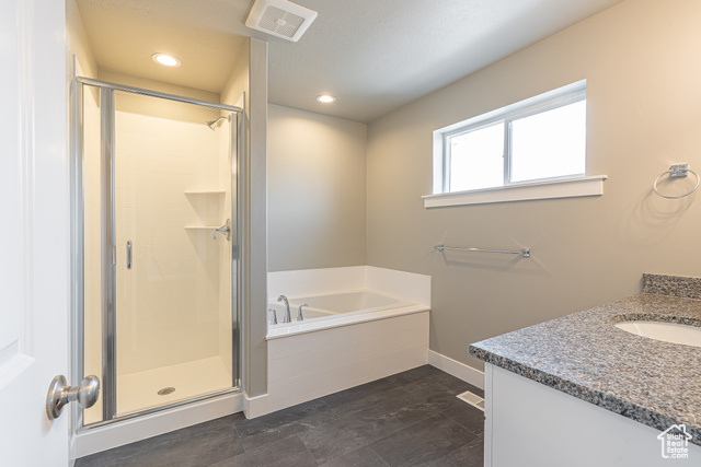 2242 South 1120 West, Unit 69 Logan, UT 84321 - Photo 22 of 26 Full bath with a bath, a stall shower, vanity, and recessed lighting