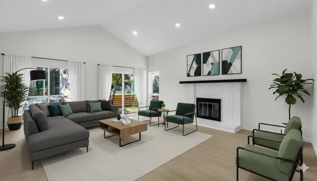 a view of an empty room with wooden floor and stairs