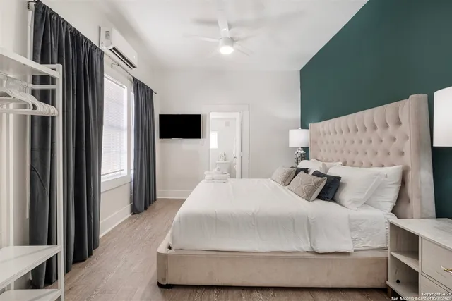 a bathroom with a shower sink mirror and toilet