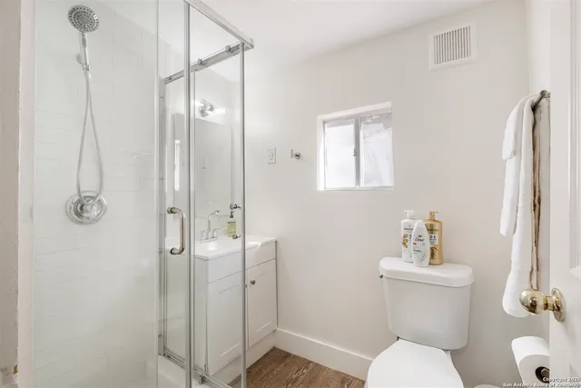 a bathroom with a shower a sink and mirror