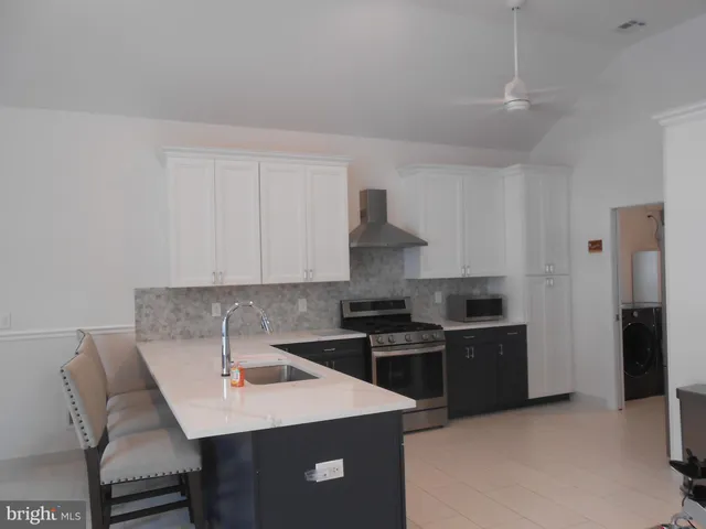 a kitchen with a sink a stove and refrigerator