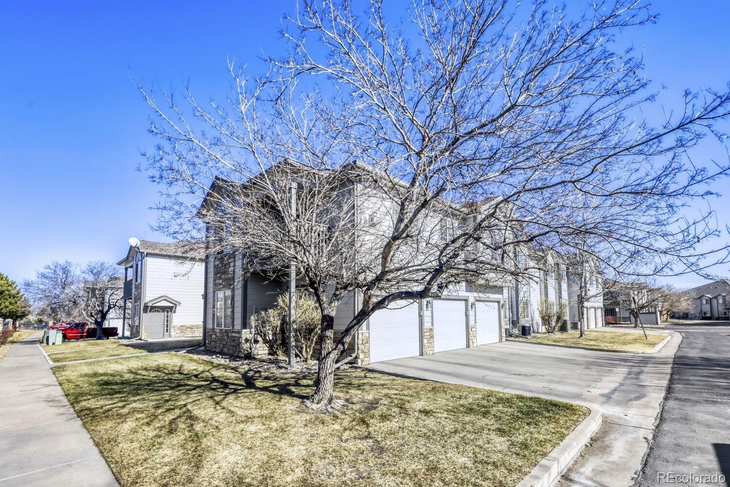 a view of a house with snow on the side of the road