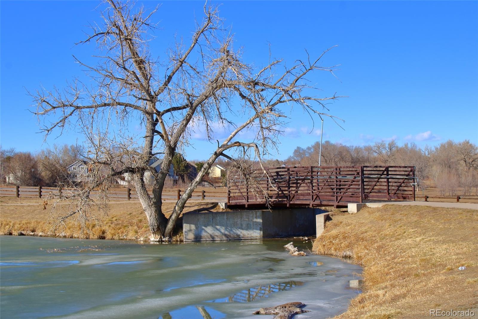 10371 Cook Way, Unit 107 Thornton, CO 80229 - Photo 24 of 34 a view of a terrace with a bench and trees around