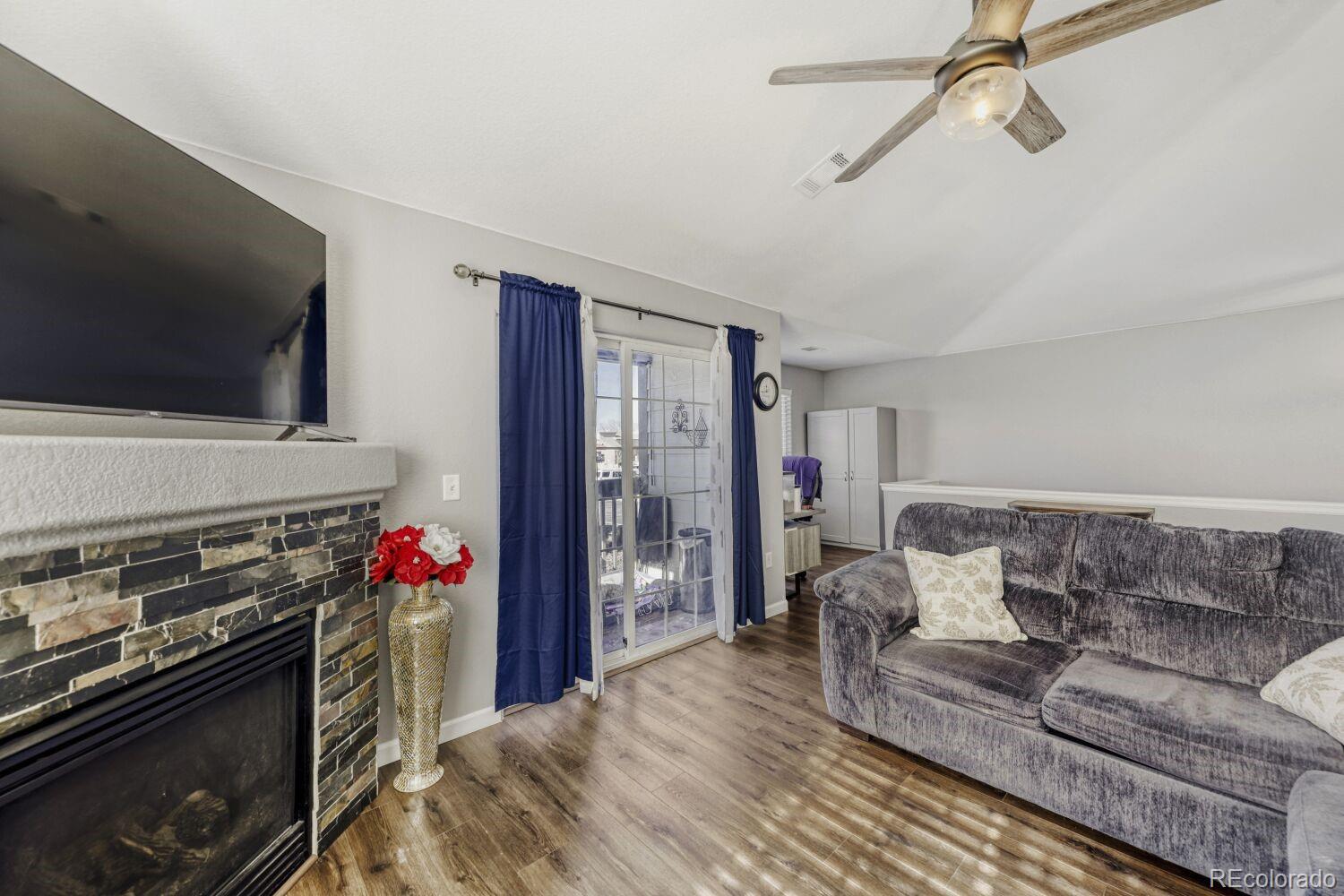 10371 Cook Way, Unit 107 Thornton, CO 80229 - Photo 5 of 34 a living room with furniture and a flat screen tv