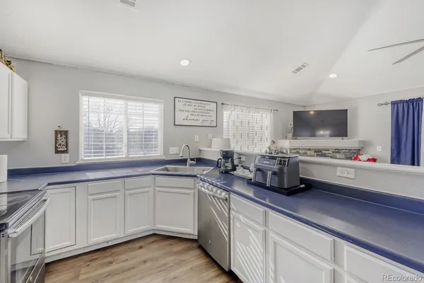 a kitchen with lots of counter space and window