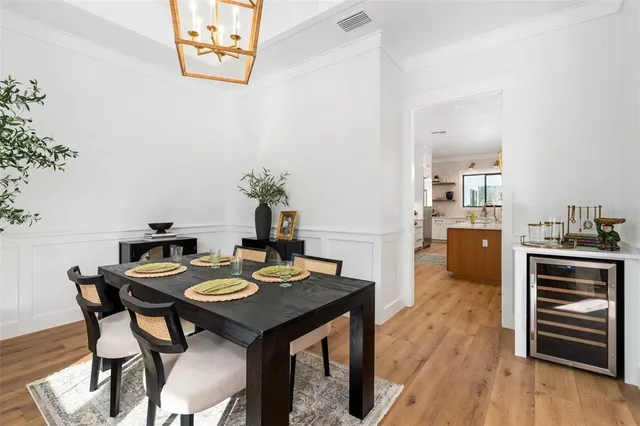 a dining room with furniture a rug and a chandelier