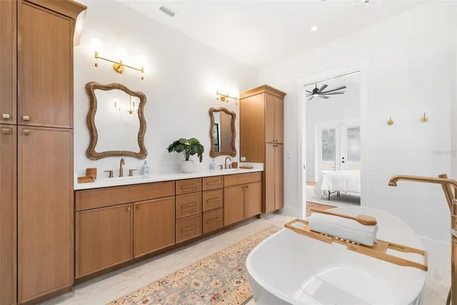 a bedroom with a bed and a ceiling fan