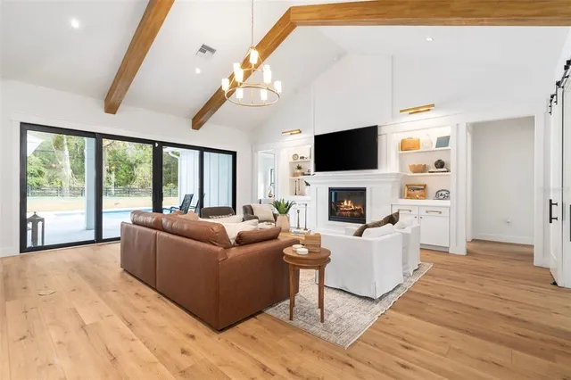 a living room with furniture a fireplace and a flat screen tv