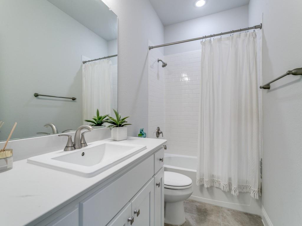 12964 Rockham Lane Dallas, TX 75234 - Photo 19 of 24 a bathroom with a sink toilet and shower