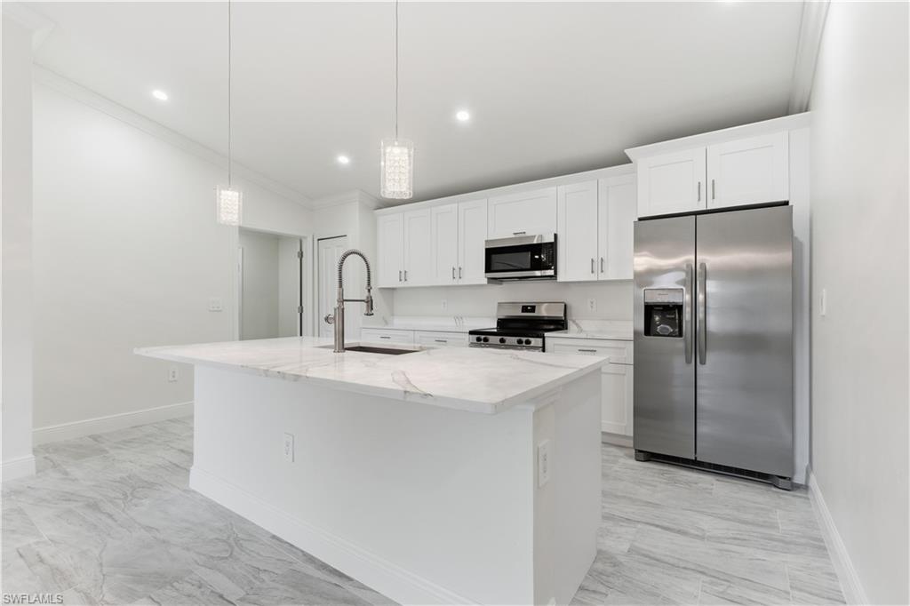 2141 Davis Street Fort Myers, FL 33916 - Photo 12 of 50 a kitchen with stainless steel appliances a refrigerator sink and microwave