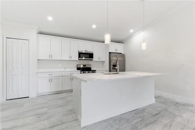 a kitchen with cabinets a sink and appliances