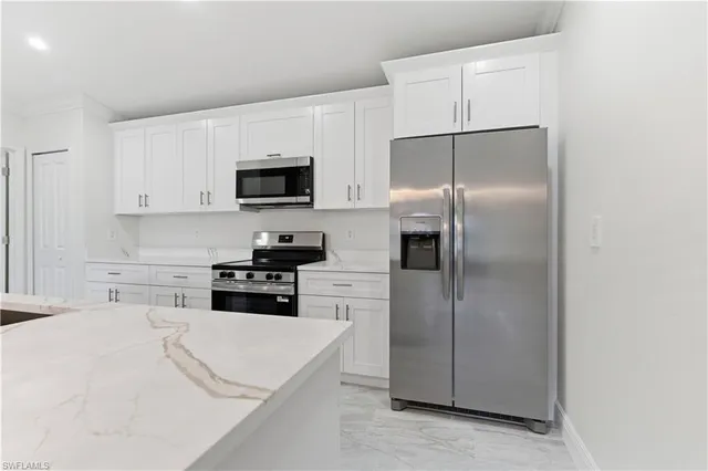 a kitchen with a refrigerator stove and microwave