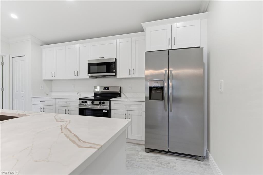 2141 Davis Street Fort Myers, FL 33916 - Photo 16 of 50 a kitchen with a refrigerator stove and microwave