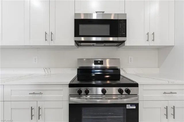 a stove top oven sitting inside of a kitchen