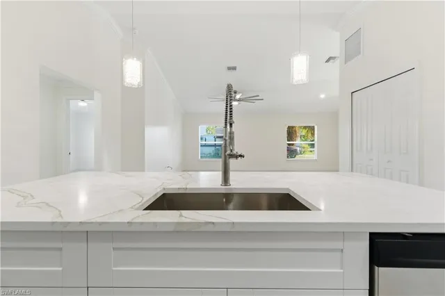 a kitchen with kitchen island a sink and counter space