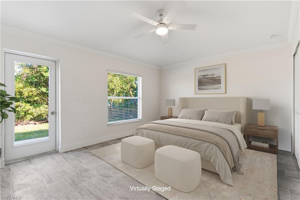 2141 Davis Street Fort Myers, FL 33916 - Photo 21 of 50 a spacious bedroom with a bed and a window