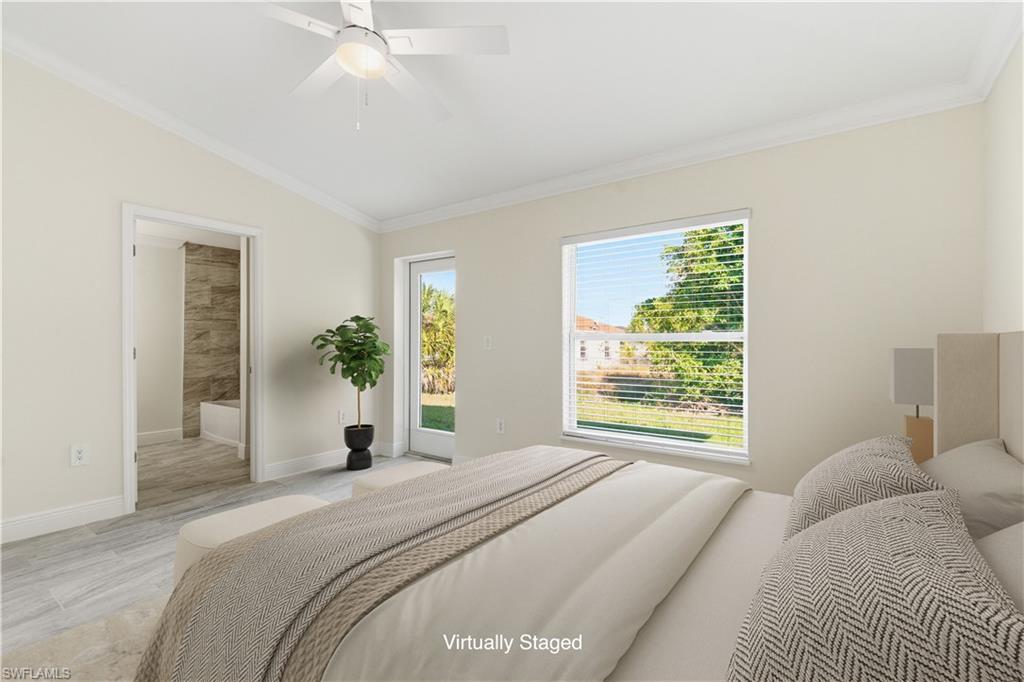 2141 Davis Street Fort Myers, FL 33916 - Photo 22 of 50 a bedroom with a large bed and a chandelier