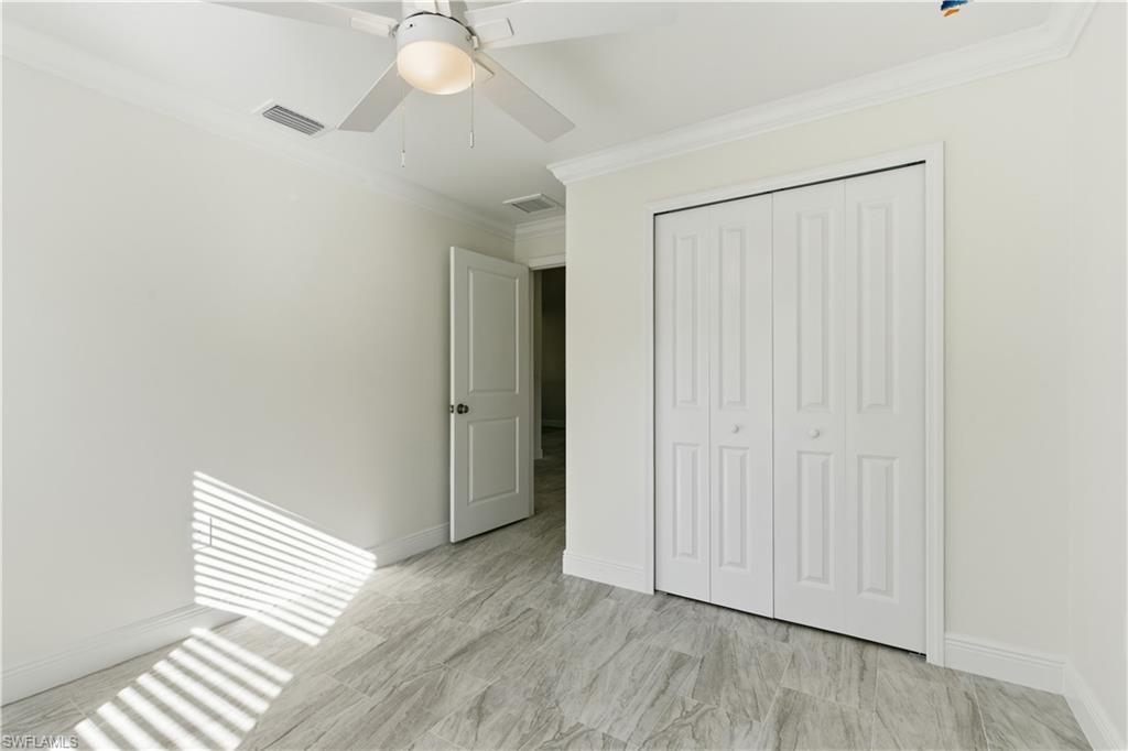 2141 Davis Street Fort Myers, FL 33916 - Photo 25 of 50 a view of empty room with wooden floor and fan