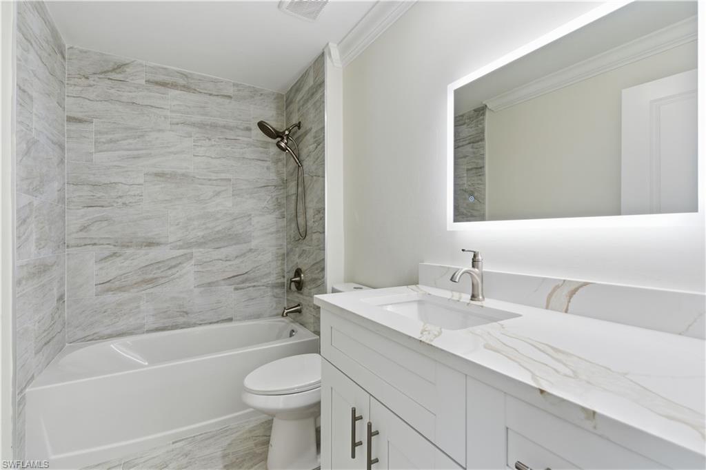 2141 Davis Street Fort Myers, FL 33916 - Photo 28 of 50 a bathroom with a sink a toilet and a bathtub