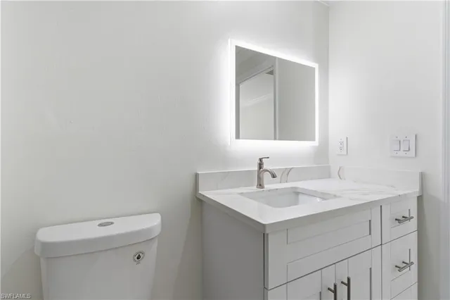 a bathroom with a sink vanity and a mirror