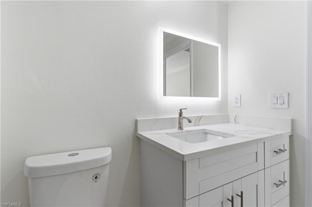 2141 Davis Street Fort Myers, FL 33916 - Photo 29 of 50 a bathroom with a sink vanity and a mirror