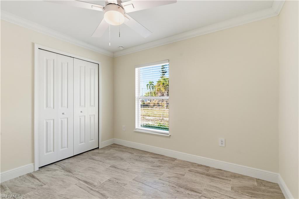 2141 Davis Street Fort Myers, FL 33916 - Photo 34 of 50 an empty room with chandelier fan and windows