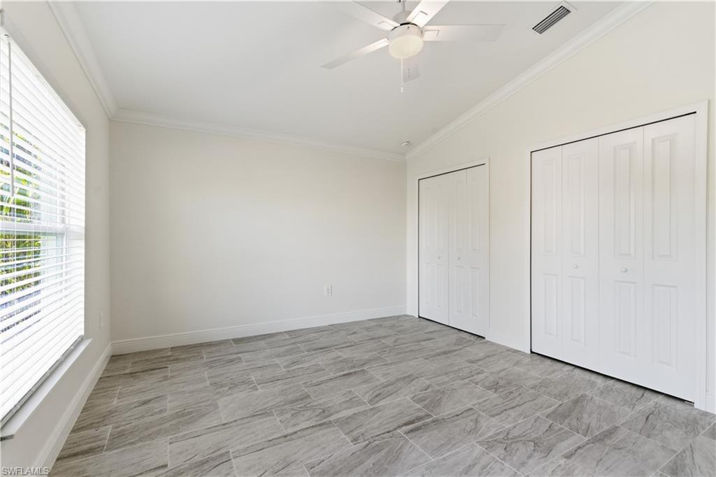 2141 Davis Street Fort Myers, FL 33916 - Photo 37 of 50 an empty room with a window and a fan