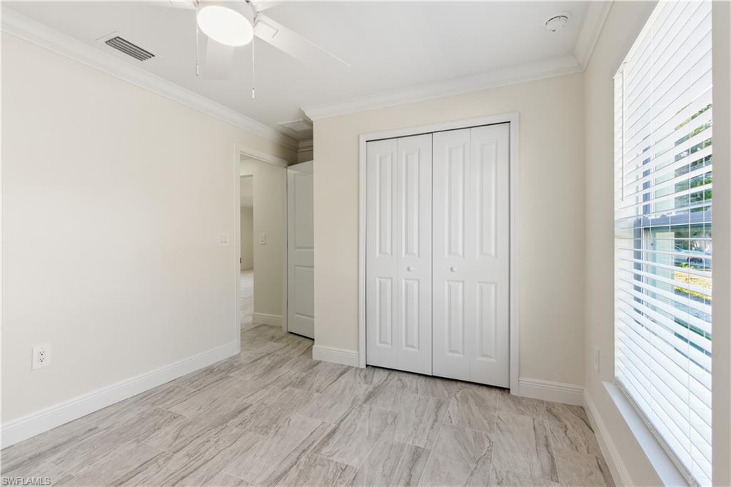 2141 Davis Street Fort Myers, FL 33916 - Photo 38 of 50 an empty room with wooden floor and windows