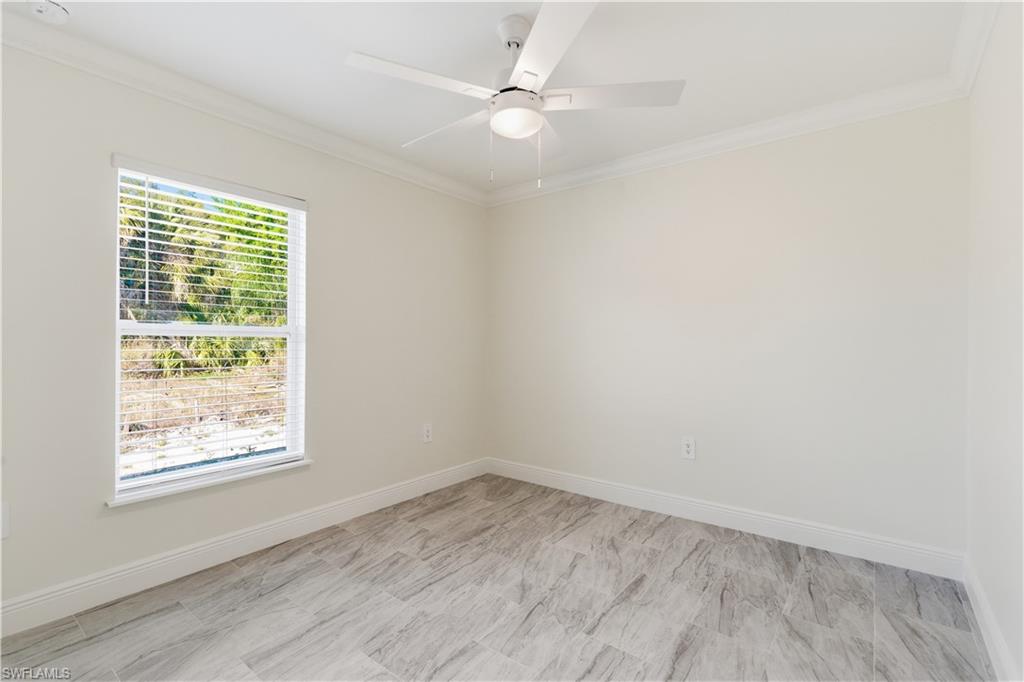 2141 Davis Street Fort Myers, FL 33916 - Photo 39 of 50 an empty room with a window and a fan