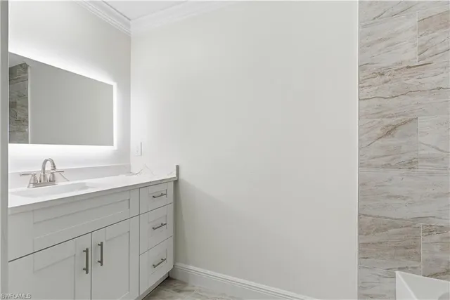 a bathroom with a sink and a mirror